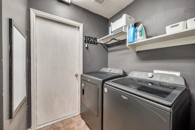 1004 Broken Spoke Dr, Little Elm, TX 75068 - washroom featuring separate washer and dryer, a textured wall, and light tile patterned flooring