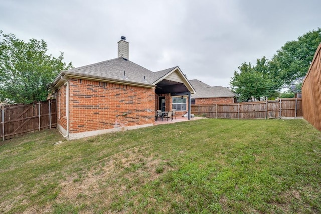 1004 Broken Spoke Dr, Little Elm, TX 75068 - rear view of property featuring brick siding, a patio area, a chimney, and roof with shingles