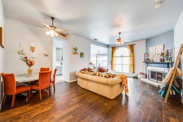 1004 Broken Spoke Dr, Little Elm, TX 75068 - living area with a ceiling fan, dark wood-style flooring, and a fireplace with raised hearth