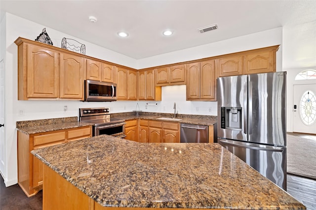 1650 Fm 36 S, Caddo Mills, TX 75135 - kitchen featuring appliances with stainless steel finishes, a sink, dark wood finished floors, dark stone counters, and recessed lighting