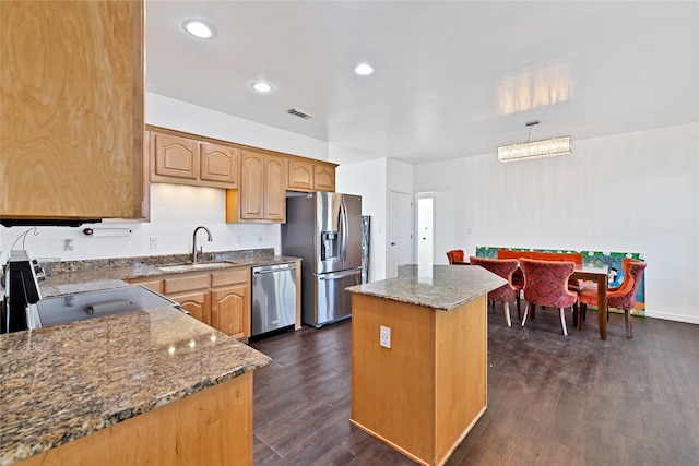 1650 Fm 36 S, Caddo Mills, TX 75135 - kitchen featuring appliances with stainless steel finishes, a sink, a kitchen island, dark wood-type flooring, and dark stone countertops