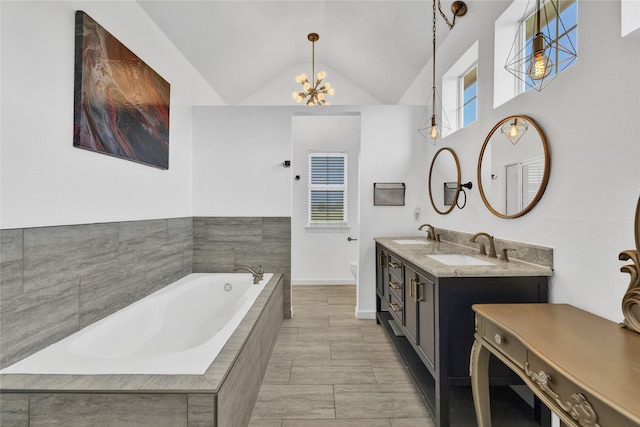 1650 Fm 36 S, Caddo Mills, TX 75135 - bathroom with toilet, a bath, double vanity, a chandelier, and vaulted ceiling