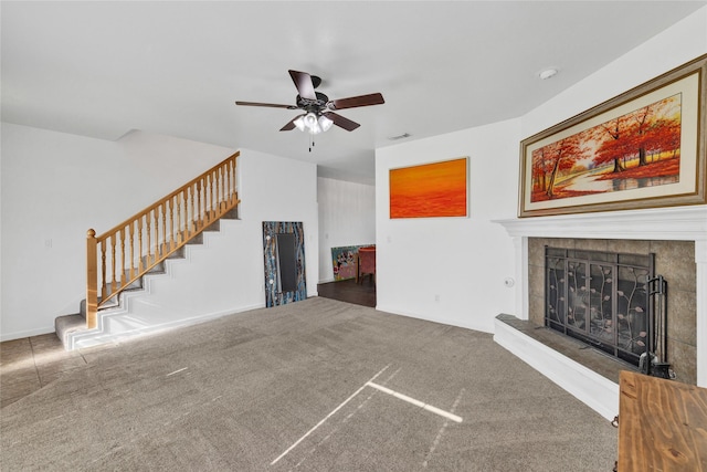 1650 Fm 36 S, Caddo Mills, TX 75135 - unfurnished living room with stairs, a ceiling fan, a tile fireplace, and carpet flooring