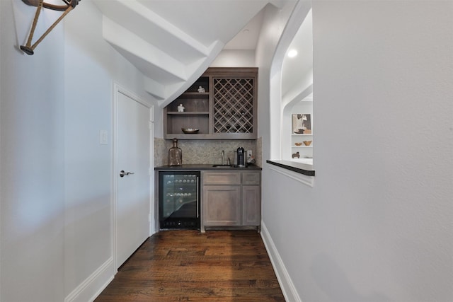 3690 Guinn Gate Dr, Frisco, TX 75034 - indoor wet bar with wine cooler, dark wood finished floors, and tasteful backsplash