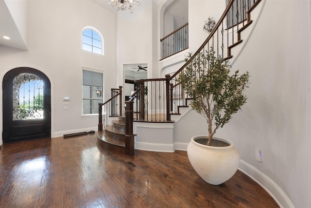 3690 Guinn Gate Dr, Frisco, TX 75034 - entrance foyer featuring wood finished floors, baseboards, a high ceiling, stairs, and arched walkways
