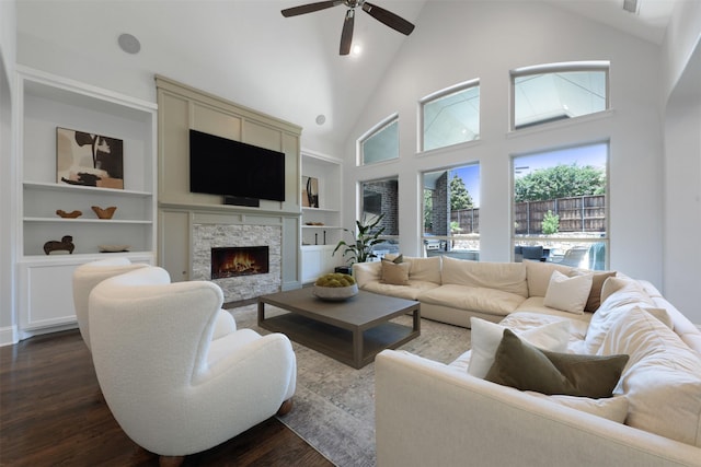 3690 Guinn Gate Dr, Frisco, TX 75034 - living room featuring dark wood finished floors, high vaulted ceiling, ceiling fan, built in shelves, and a fireplace