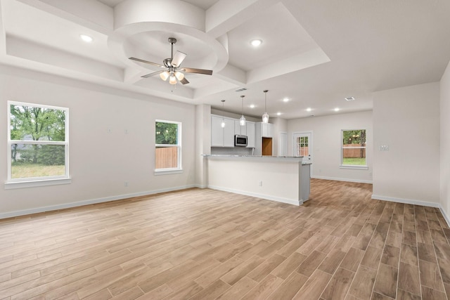 301 Kalura Way, Tool, TX 75143 - unfurnished living room featuring coffered ceiling, ceiling fan, recessed lighting, light wood-style floors, and baseboards
