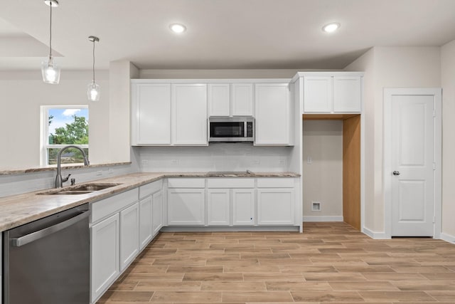 301 Kalura Way, Tool, TX 75143 - kitchen featuring appliances with stainless steel finishes, a sink, white cabinetry, backsplash, and recessed lighting