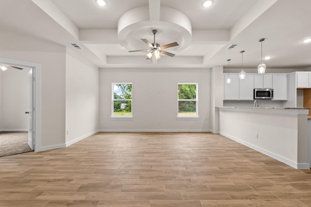 301 Kalura Way, Tool, TX 75143 - kitchen featuring stainless steel microwave, a ceiling fan, white cabinets, a raised ceiling, and recessed lighting