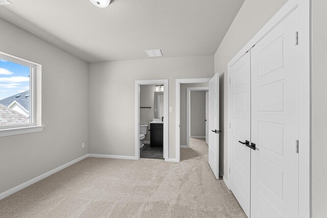 2013 Tolleson Dr, Fort Worth, TX 76008 - unfurnished bedroom with light carpet, baseboards, a closet, and connected bathroom
