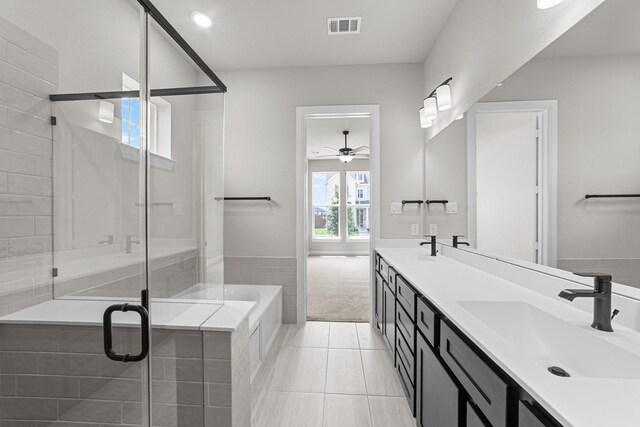 2013 Tolleson Dr, Fort Worth, TX 76008 - bathroom featuring double vanity, a bath, a ceiling fan, a stall shower, and tile patterned flooring