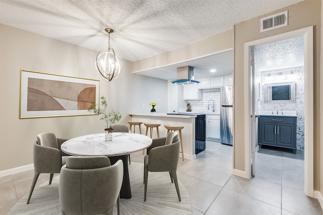 5833 Harvest Hill Rd Unit 2071, Dallas, TX 75230 - dining area featuring light tile patterned floors, a chandelier, a textured ceiling, and baseboards