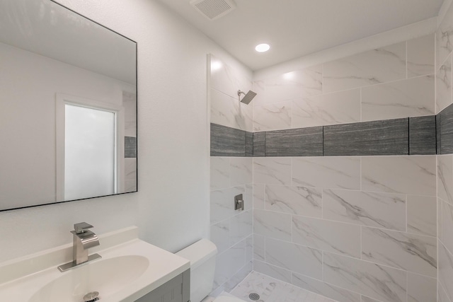 11417 Park Central Pl, Dallas, TX 75230 - full bathroom featuring vanity, a tile shower, and toilet