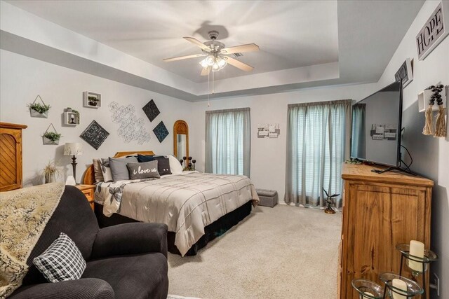 2215 Albert Broadfoot St, Bonham, TX 75418 - carpeted bedroom featuring a tray ceiling, a ceiling fan, and baseboards