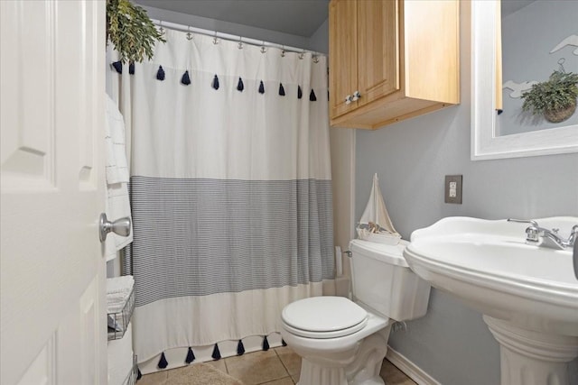 2215 Albert Broadfoot St, Bonham, TX 75418 - bathroom featuring toilet, tile patterned floors, curtained shower, baseboards, and a sink