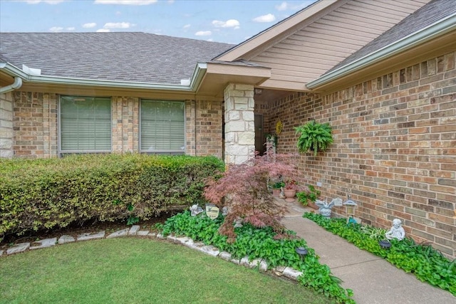 2215 Albert Broadfoot St, Bonham, TX 75418 - doorway to property with a shingled roof, a yard, and brick siding