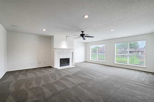 6018 San Marino Ct, Rowlett, TX 75089 - unfurnished living room featuring carpet flooring, recessed lighting, ceiling fan, a tile fireplace, and a textured ceiling