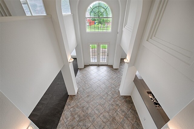 6018 San Marino Ct, Rowlett, TX 75089 - entryway featuring healthy amount of natural light, a towering ceiling, a textured wall, baseboards, and french doors