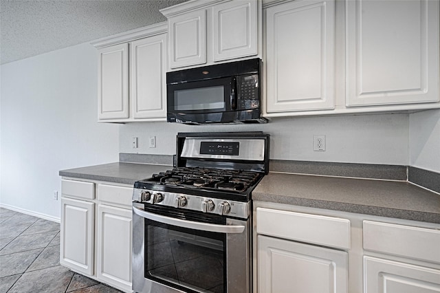 6018 San Marino Ct, Rowlett, TX 75089 - kitchen featuring stainless steel range with gas cooktop, black microwave, dark countertops, white cabinets, and light tile patterned flooring