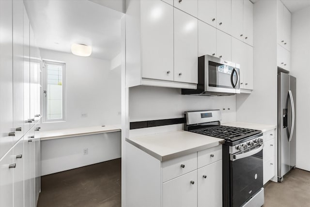33 Vanguard Way, Dallas, TX 75243 - kitchen featuring appliances with stainless steel finishes, concrete floors, white cabinets, and light countertops
