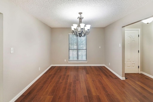 243 Barclay Ave, Coppell, TX 75019 - spare room with a chandelier, wood finished floors, a textured ceiling, and baseboards