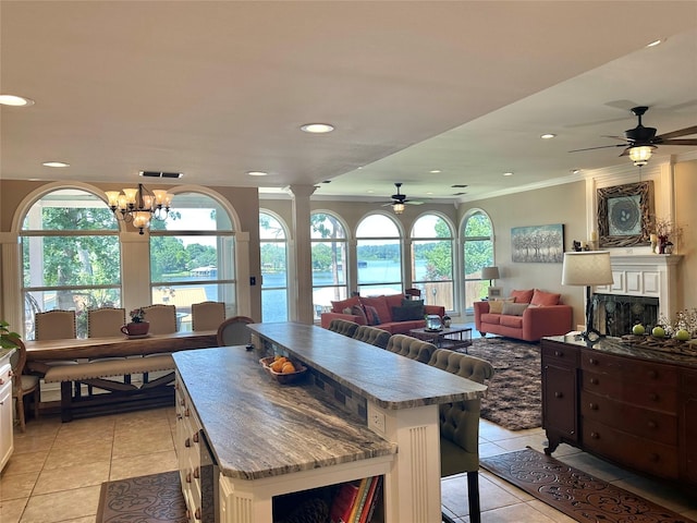 13449 S Hillcreek Rd, Whitehouse, TX 75791 - kitchen with light tile patterned floors, a ceiling fan, a kitchen island, plenty of natural light, and recessed lighting