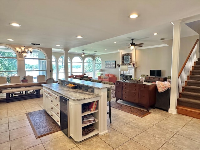 13449 S Hillcreek Rd, Whitehouse, TX 75791 - kitchen with ornate columns, a ceiling fan, crown molding, open shelves, and healthy amount of natural light