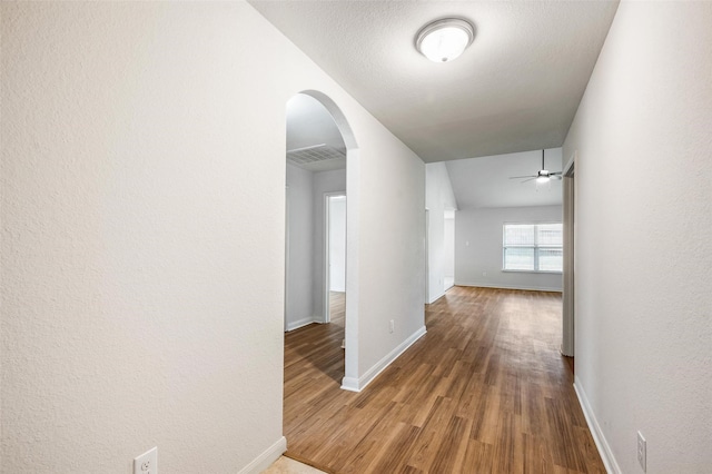 1206 Lombardy Dr, Princeton, TX 75407 - corridor with arched walkways, wood finished floors, and baseboards