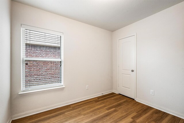 1206 Lombardy Dr, Princeton, TX 75407 - unfurnished room featuring wood finished floors, plenty of natural light, and baseboards