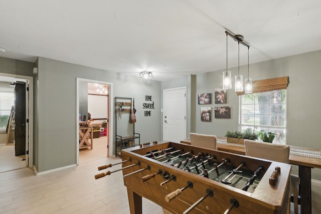 945 Lake Ridge Dr, Azle, TX 76020 - rec room with healthy amount of natural light, light wood finished floors, and baseboards