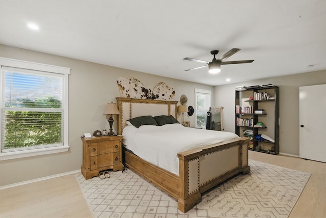 945 Lake Ridge Dr, Azle, TX 76020 - bedroom with light wood-style floors, a ceiling fan, and baseboards