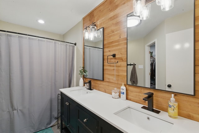 945 Lake Ridge Dr, Azle, TX 76020 - full bathroom with double vanity, wood walls, and curtained shower