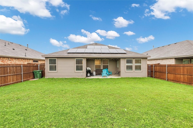 16561 Portage St, Justin, TX 76247 - rear view of property featuring roof mounted solar panels and a patio area