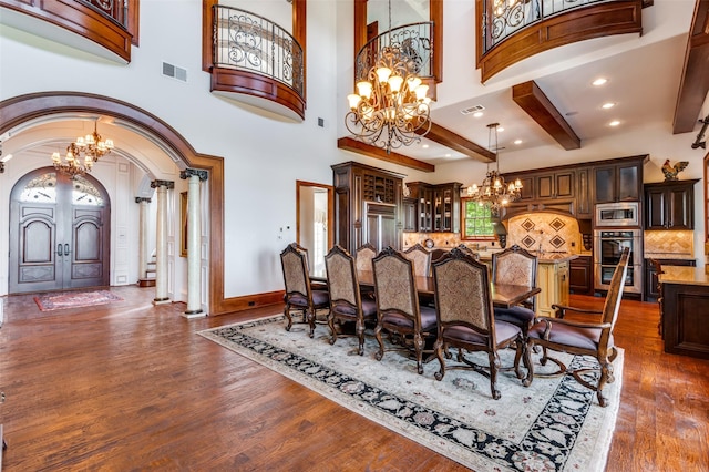 2145 Grand View Ct, Cedar Hill, TX 75104 - dining room with a chandelier, arched walkways, dark wood finished floors, baseboards, and decorative columns