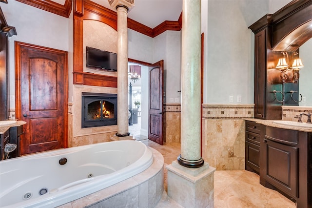 2145 Grand View Ct, Cedar Hill, TX 75104 - bathroom featuring crown molding, vanity, a tub with jets, a glass covered fireplace, and a wainscoted wall