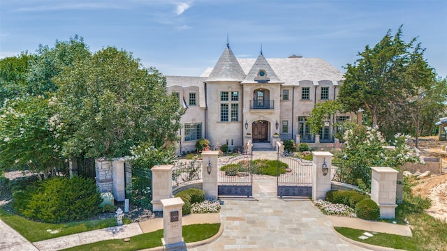 2145 Grand View Ct, Cedar Hill, TX 75104 - french country style house featuring a gate, a fenced front yard, and stucco siding
