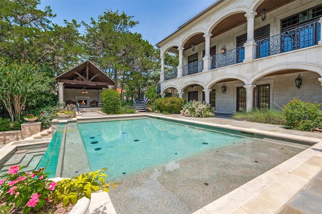 2145 Grand View Ct, Cedar Hill, TX 75104 - swimming pool with a patio and a warm lit fireplace
