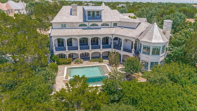 2145 Grand View Ct, Cedar Hill, TX 75104 - back of property with a balcony, a chimney, an outdoor pool, and stucco siding