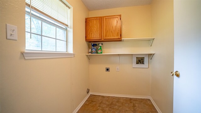 906 Pear Ct, Joshua, TX 76058 - laundry room with hookup for a washing machine, hookup for an electric dryer, cabinet space, baseboards, and a textured ceiling
