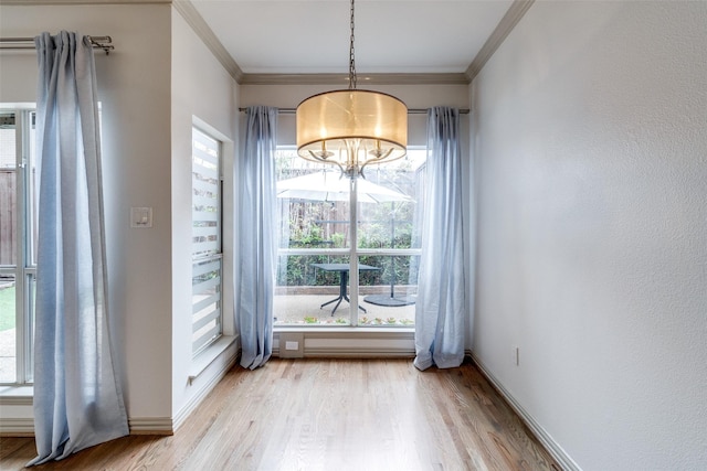 3719 Douglas Ave, Dallas, TX 75219 - unfurnished dining area featuring crown molding, light wood finished floors, plenty of natural light, and a chandelier