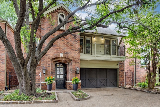 3719 Douglas Ave, Dallas, TX 75219 - view of front facade featuring brick siding, a balcony, and a garage