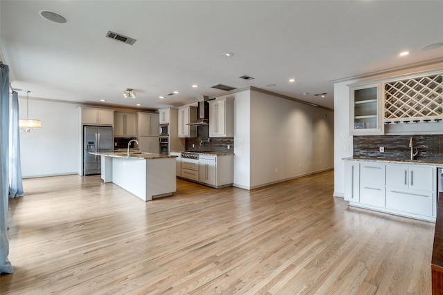 3719 Douglas Ave, Dallas, TX 75219 - indoor wet bar with light wood finished floors, crown molding, tasteful backsplash, stairs, and recessed lighting