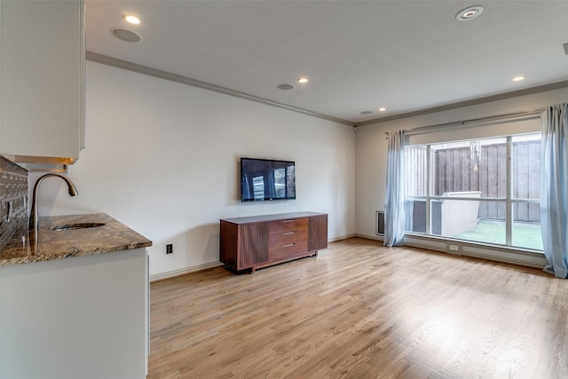 3719 Douglas Ave, Dallas, TX 75219 - kitchen with ornamental molding, appliances with stainless steel finishes, wall chimney exhaust hood, dark stone counters, and decorative backsplash