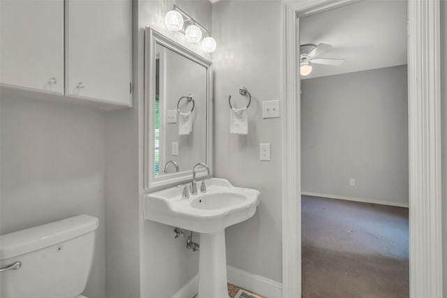 11406 Drummond Dr, Dallas, TX 75228 - bathroom featuring toilet, ceiling fan, and baseboards