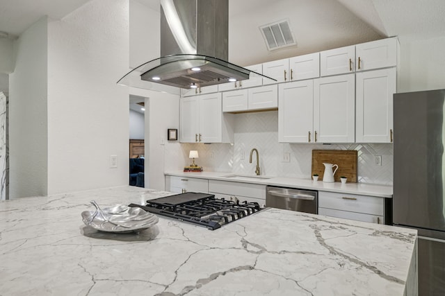 6607 Leameadow Dr, Dallas, TX 75248 - kitchen with appliances with stainless steel finishes, a sink, wall chimney exhaust hood, decorative backsplash, and light stone counters