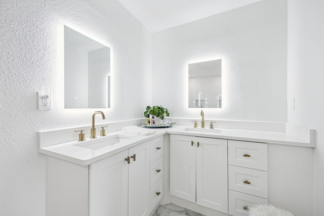 6607 Leameadow Dr, Dallas, TX 75248 - full bath featuring double vanity, a textured wall, and marble finish floors