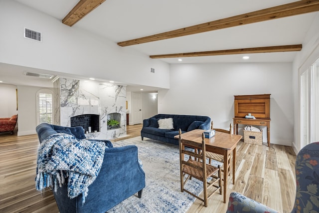 6607 Leameadow Dr, Dallas, TX 75248 - living area featuring light wood finished floors, a high end fireplace, recessed lighting, beam ceiling, and baseboards