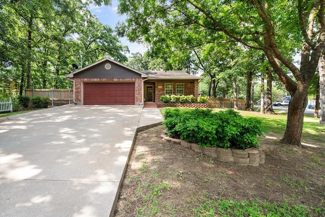 143 Doe Run Rd, Gun Barrel City, TX 75156 - view of front of property with a garage, concrete driveway, and brick siding