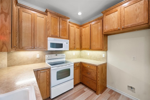 143 Doe Run Rd, Gun Barrel City, TX 75156 - kitchen featuring white appliances, light countertops, a sink, light wood-type flooring, and backsplash