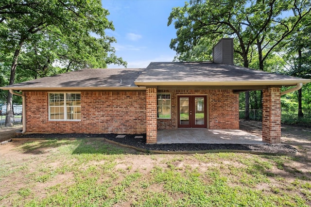 143 Doe Run Rd, Gun Barrel City, TX 75156 - rear view of house featuring french doors, a chimney, brick siding, and a patio